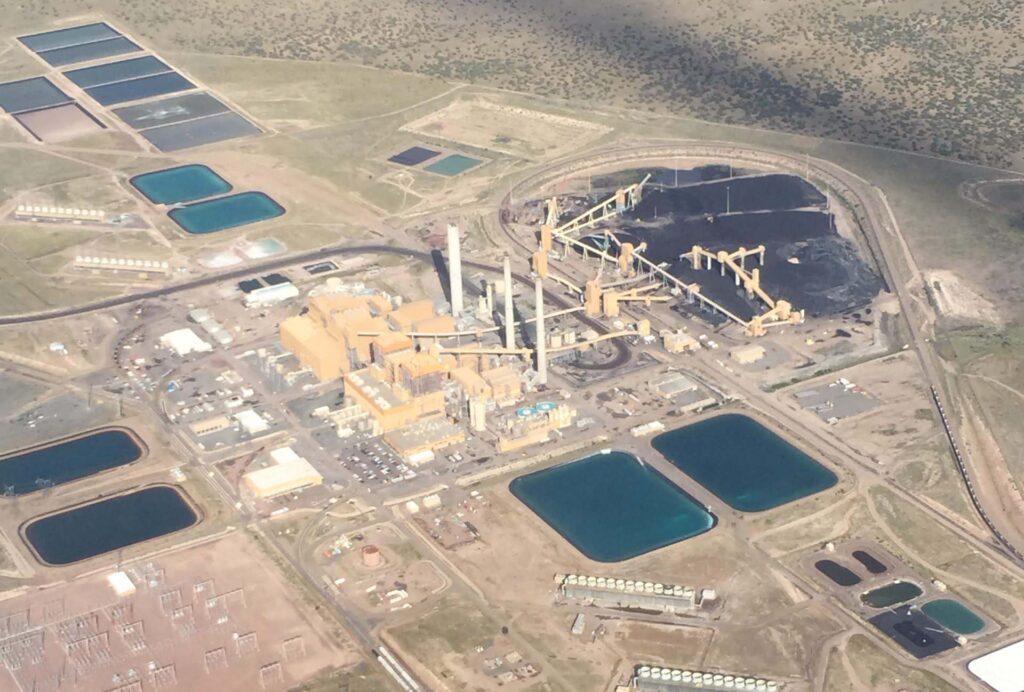 Aerial view of a large coal-fired power generation facility with fuel handling infrastructure, stockpiles, and wastewater ponds, illustrating Halker’s engineering capabilities in coal additive systems, emissions reduction strategies, and operational performance optimization for industrial energy plants.