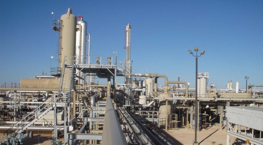 High-pressure gas compressor station with interconnected process piping, vertical vessels, and structural platforms, demonstrating Halker’s expertise in midstream facility engineering, compressor optimization, and safe, reliable natural gas handling infrastructure.