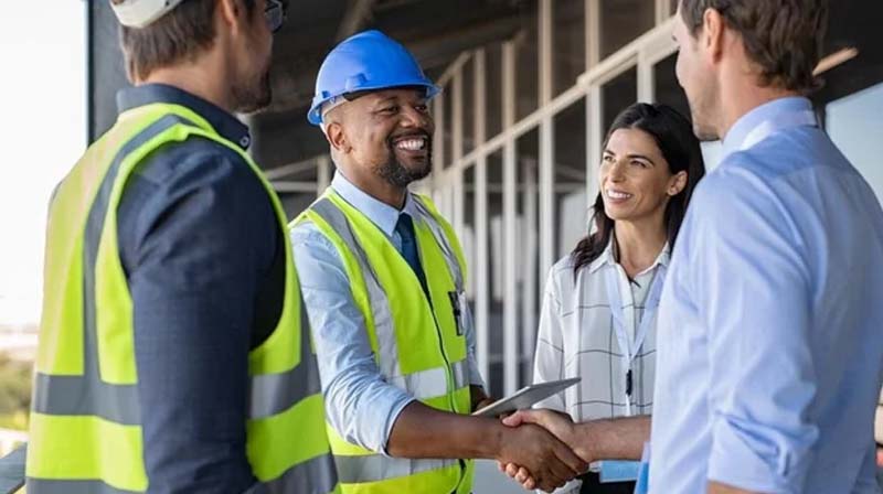 Construction and engineering professionals shaking hands on-site, highlighting Halker’s commitment to collaborative project delivery, contractor coordination, and strong client partnerships in industrial and energy-sector projects.