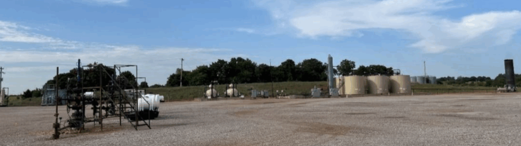 Oil and gas production site with storage vessels, process equipment, and monitoring infrastructure, highlighting Halker’s expertise in OOOOc compliance walkdowns, regulatory assessments, and emissions-reduction solutions for upstream facilities.