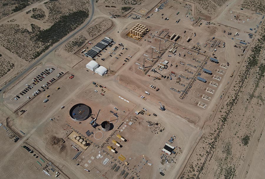 Aerial view of a large-scale oil and gas construction site featuring tank foundations, equipment laydown areas, crane operations, and infrastructure staging, demonstrating Halker’s expertise in managing complex upstream facility development and EPCM project execution.