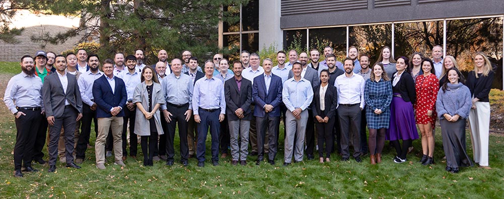 Large group photo of Halker employees standing outside the office building, highlighting the company’s collaborative culture, diverse engineering talent, and team-driven approach to delivering energy and infrastructure solutions.