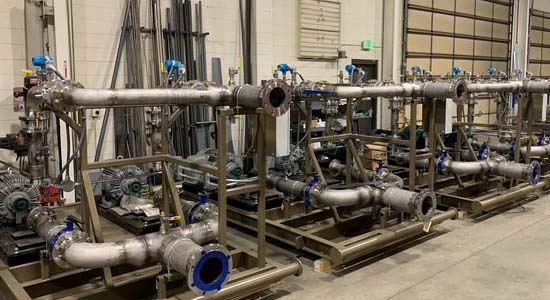 Row of large industrial butterfly valves in a manufacturing facility, highlighting Halker’s expertise in specifying, procuring, and integrating high-capacity flow control equipment for complex energy and industrial infrastructure projects.