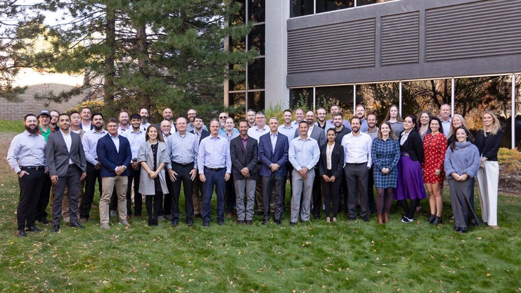 Large group photo of Halker employees standing outside the office building, highlighting the company’s collaborative culture, diverse engineering talent, and team-driven approach to delivering energy and infrastructure solutions.